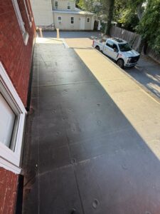 Solving Persistent Leaks with a New EPDM Porch Roof & Entry Door